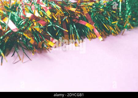 Guirlande de Noël colorée sur fond rose. Gros plan, espace de copie. Banque D'Images