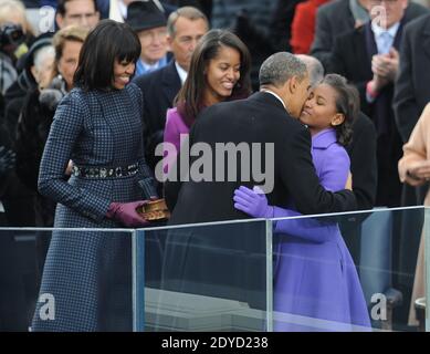 Barack Obama encende sa fille Sasha en tant qu'autre fille Malia et épouse Michelle regarder sur les cérémonies d'inauguration pour le second mandat du président Obama au Capitole des États-Unis à Washington, DC, Etats-Unis, le 21 janvier 2013. Photo de JMP-Douliery/ABACAPRESS.COM Banque D'Images