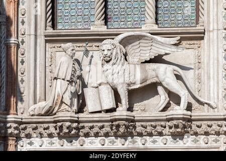 Venise Italie le Lion de St Marc sur la plate-forme centrale au-dessus de l'entrée principale, ou 'Porta della Carta'. Banque D'Images