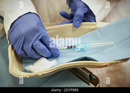 Gros plan main d'une femme médecin portant un masque de protection en laboratoire tenir la seringue avec le vaccin coronavirus de Pfizer, à l'hôpital Amedeo di Savoia. Tu Banque D'Images