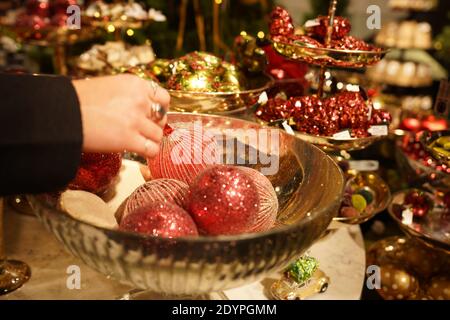 Shopping de Noël, boule rose à la main. Achat de superbes boules de luxe en magasin à Zurich en Suisse. Banque D'Images
