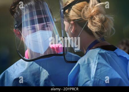 Deux médecins parlant portant un respirateur et un masque facial en plastique. Banque D'Images