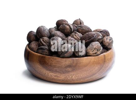 Heap  of freshly harvested english walnuts in the wooden plate Stock Photo