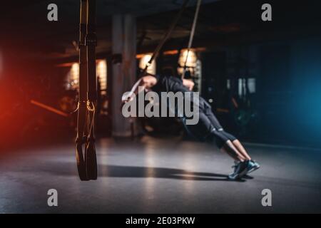 jeune homme a crossfit entraînement avec trx dans la salle de gym moderne Banque D'Images