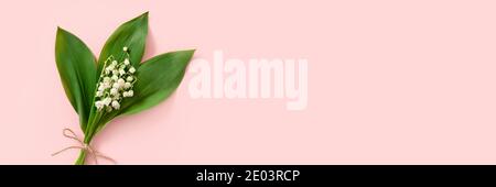 Tête avec bouquet de lis de fleurs de la vallée. Cadeau pour la fête des mères sur fond rose. Concept de ressort. Banque D'Images