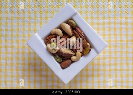 Bol de noix, noix de cajou, amandes, braises, pacanes et pistaches, noix non salées sur une serviette de serviette - pour les fêtes de Noël Banque D'Images