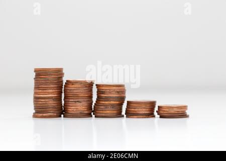 Vue latérale des piles de pièces de monnaie augmentant en hauteur, sur fond blanc studio isolé, business et concept financier Banque D'Images