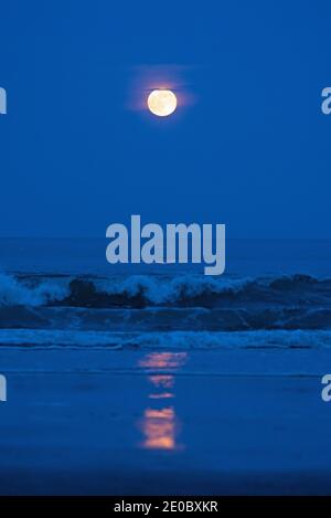 La pleine lune de fraises s'élève au-dessus de l'océan Atlantique Banque D'Images