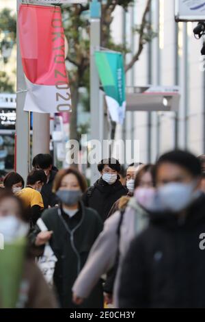 Tokyo, Japon. 31 décembre 2020. Des piétons portant des masques faciaux marchent sur une route à Tokyo, Japon, 31 décembre 2020. Le nombre de nouveaux cas quotidiens de COVID-19 à Tokyo a dépassé le seuil des 1,000 pour la première fois depuis l'épidémie, a déclaré le gouverneur Yuriko Koike jeudi, avertissant que la troisième vague qui frappe la capitale est de « taille sans précédent ». Credit: Du Xiaoyi/Xinhua/Alay Live News Banque D'Images