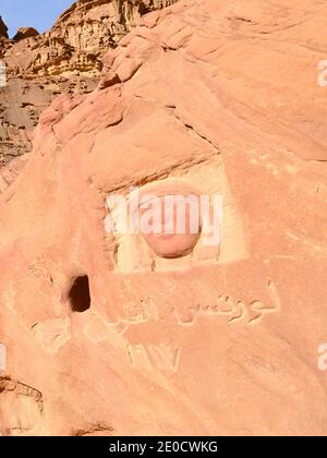 Effigy de T. E. Lawrence sculpté dans la roche dans le désert de Wadi Rum en Jordanie. Lawrence d'Arabie face à la sculpture. Banque D'Images