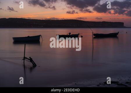 Bateaux de pêche sur une mer de rivière au coucher du soleil à Foz do Arelho, Portugal Banque D'Images