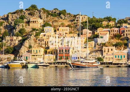 Soleil en fin d'après-midi sur les demeures néoclassiques du port de Gialos, île de Symi, Dodécanèse, Grèce Banque D'Images