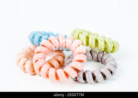 Groupe de bandes en caoutchouc spirales colorées. Attaches élastiques aux couleurs vives sur fond blanc. Banque D'Images