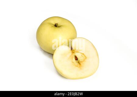 Une pomme et demie isolée sur fond blanc. Fruits jaunes tranchés Banque D'Images