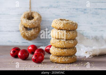 Biscuits traditionnels grecs de Pâques avec graines de sésame et œufs de couleur sur la table en bois, foyer sélectif Banque D'Images