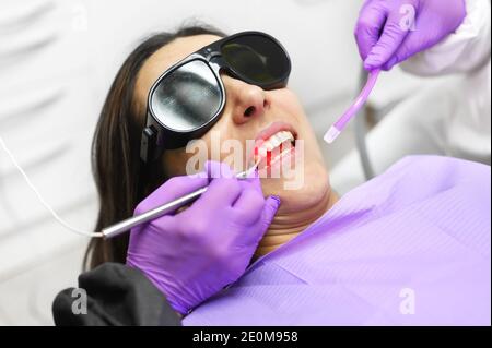 Dentiste utilisant UN laser dentaire à diode moderne. Photo de haute qualité Banque D'Images