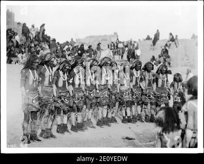 Ligne d'une douzaine de serpent Hopi prêtres chantant des chansons et des prières avant la kiva ou kisi du pueblo de Oraibi, Arizona, 1898 Banque D'Images