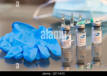 LONDRES, ANGLETERRE - DÉCEMBRE 13 : un jeu de flacons en verre contenant la solution vaccinale Pfizer BioNtec COVID-19 coronavirus prête à être utilisée avec une seringue i. Banque D'Images
