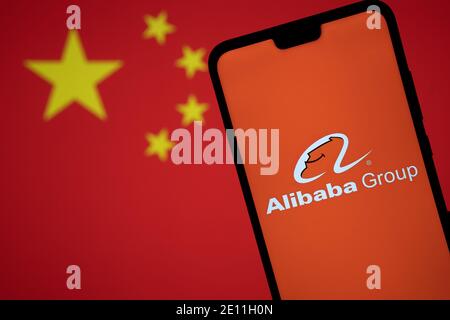 Stafford, Royaume-Uni - janvier 3 2021 : logo Alibaba sur une silhouette de smartphone et drapeau flou de la Chine. Concept pour le gouvernement et la technologie g Banque D'Images