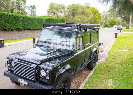 2009 défenseur Land Rover en noir garée dans une rue à Avalon Beach à Sydney, en Australie, avec auvent darche installé Banque D'Images