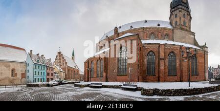 Vue panoramique sur l'église Saint-Pierre et bâtiments historiques entourés en hiver dans la vieille ville de Riga, Lettonie Banque D'Images