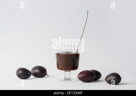 Bol avec une délicieuse confiture de prunes maison sur fond blanc Banque D'Images