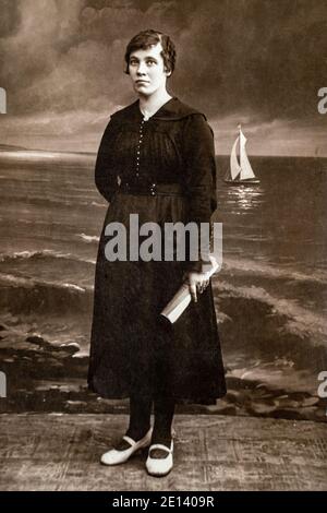 RUSSIE - VERS les années 1920 : photo du corps entier des femmes en studio Vintage carte de Viste Edwardian Era. Mer peinte avec arrière-plan de bateau à voile Banque D'Images
