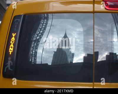 Le bâtiment Chrysler se reflète dans la lunette arrière du taxi Banque D'Images