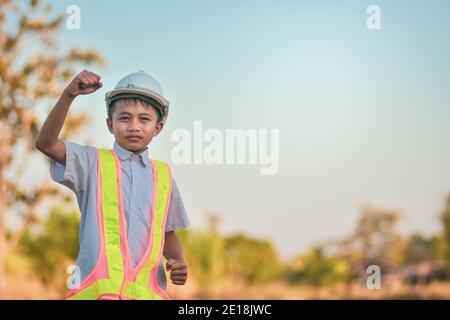 Garçon enfant Ingénieur debout extérieur main de retenue de succès concept Banque D'Images