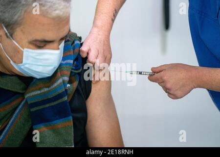 Infirmière vaccinant un homme avec le vaccin Pfizer-BioNTech Covid 19 Banque D'Images