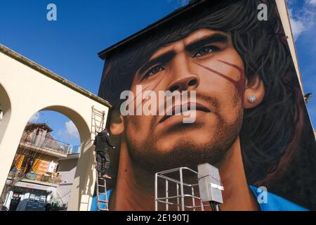 Naples, Italie. 04e janvier 2021. Jorit Agoch, artiste de rue napolitaine, a créé sa nouvelle fresque en Quarto, dans la province de Naples, représentant le visage de Diego Armando Maradona, décédé le 25 novembre 2020, Dique Luján, Argentine, ancien joueur de la ssc napoli de 1984 à 1991. La figure de maradona à naples et dans la province est vénérée comme un saint. Crédit : Agence photo indépendante/Alamy Live News Banque D'Images