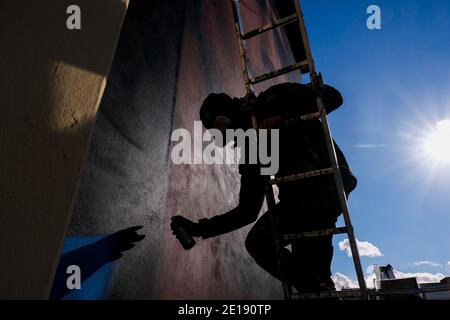 Naples, Italie. 04e janvier 2021. Jorit Agoch, artiste de rue napolitaine, a créé sa nouvelle fresque en Quarto, dans la province de Naples, représentant le visage de Diego Armando Maradona, décédé le 25 novembre 2020, Dique Luján, Argentine, ancien joueur de la ssc napoli de 1984 à 1991. La figure de maradona à naples et dans la province est vénérée comme un saint. Crédit : Agence photo indépendante/Alamy Live News Banque D'Images