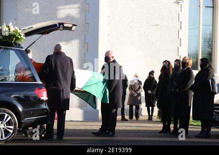 Bernadette Sands McKevitt (deuxième à droite), l'épouse de l'ancien vrai dirigeant de l'IRA Michael McKevitt, observe que son cercueil arrive à l'église pour ses funérailles à Blackrock, Co Louth. Banque D'Images