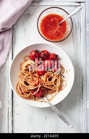 Pâtes spaghetti à la sauce tomate et tomates cerises grillées. Banque D'Images