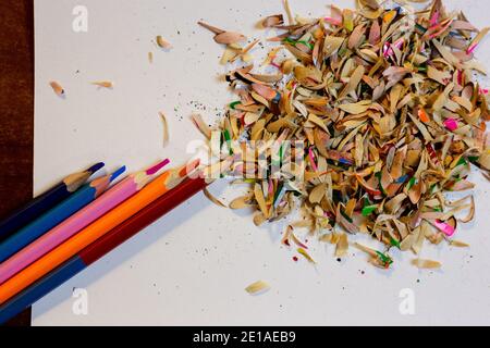 Crayons de couleur et copeaux après l'aiguisage des crayons sur un blanc feuille Banque D'Images