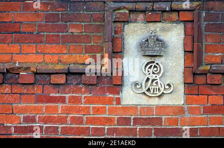 Le monogramme du roi Edward VII est sculpté dans UNE plaque de pierre fixée sur le côté d'un mur de briques rouges anciennes, sur le côté de Holmsley Toll House, New Forest UK Banque D'Images