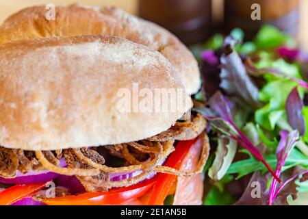 Gros plan du sandwich Salmon Gravlax avec le duo oignons, son pain frais est clairement vu, avec d'autres légumes. Banque D'Images