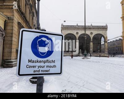 6 janvier 2021, Munich, Bavière, Allemagne : Un panneau d'exigence de masque en face de la Feldherrnhalle à Munich, Allemagne pendant la première tempête de neige notable de 2021 et la première tempête de neige réelle de l'hiver 2020/2021.Ã‚la région n'a vu qu'un dépoussiérage précédent de neige.Ã‚la neige coïncide également avec Epiphany (ger: heilige Drei Koenige, les trois rois saints) (Credit image: © Sachelle Babbar/ZUMA Wire) Banque D'Images