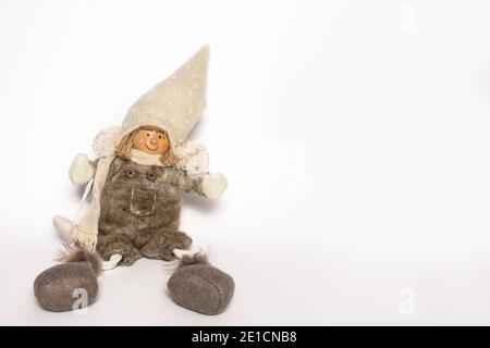 Poupée artisanale fille dans des vêtements chauds et chapeau fait à la main se trouve sur fond blanc avec espace de copie. Vue avant Banque D'Images