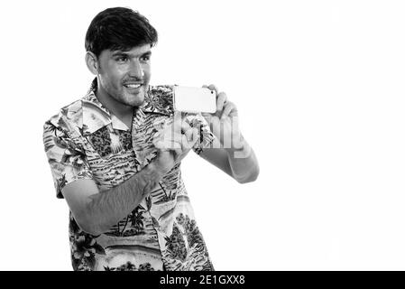 Happy young man smiling persique pendant la prise de photo avec un téléphone mobile Banque D'Images