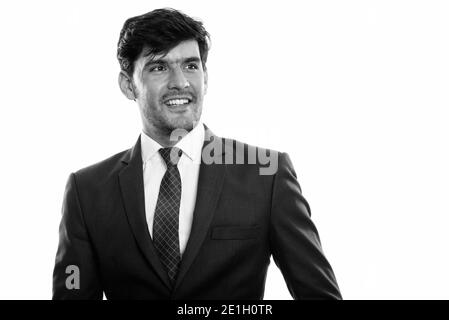 Studio shot of young businessman smiling persan heureux en pensant à la recherche et à distance Banque D'Images