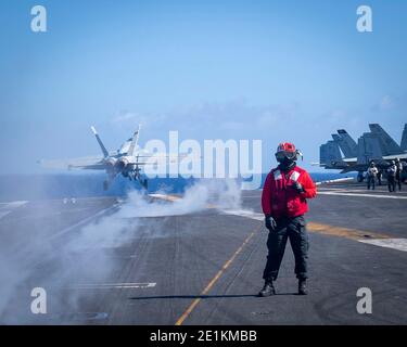 Un avion de chasse Super Hornet F/A-18e de la Marine américaine, affecté au Golden Warriors of Strike Fighter Squadron 87, est lancé à partir du pont de vol du porte-avions USS Theodore Roosevelt de la classe Nimitz pendant les opérations du 30 décembre 2020 dans l'océan Pacifique. Banque D'Images