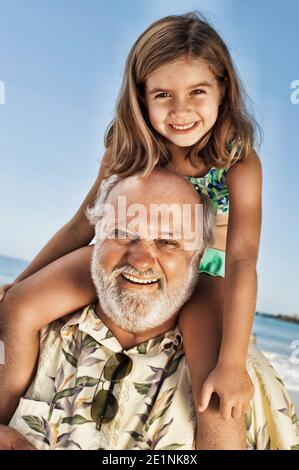Photo du grand-père qui donne la petite-fille à la promenade de piggy Banque D'Images