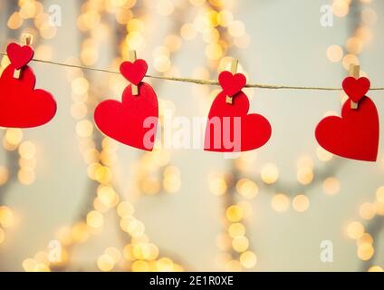 Joyeux Saint-Valentin fond avec coeur rouge accrocher avec la corde à linge avec fond de bokeh, design romantique, carte de voeux ou espace de copie Banque D'Images