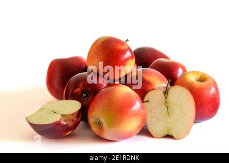 Groupe de pommes fraîches rouges, entières et coupées, sur fond blanc. Banque D'Images