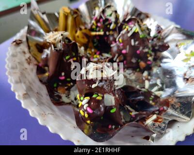 gros plan d'un plat au chocolat dans le désert avec des couleurs vives décoration sur elle dans une assiette blanche servi Banque D'Images