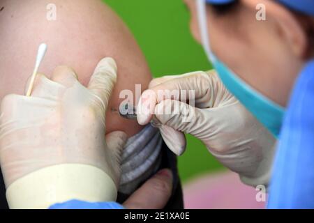 Pékin, Chine. 10 janvier 2021. Un travailleur médical inocule un receveur avec un vaccin COVID-19 à l'hôpital universitaire de Pékin, à Beijing, capitale de la Chine, le 10 janvier 2021. Beijing est prévu de terminer l'inoculation pour les groupes clés avant le Festival de printemps, qui se déroule le 12 février de cette année. Crédit: REN Chao/Xinhua/Alay Live News Banque D'Images