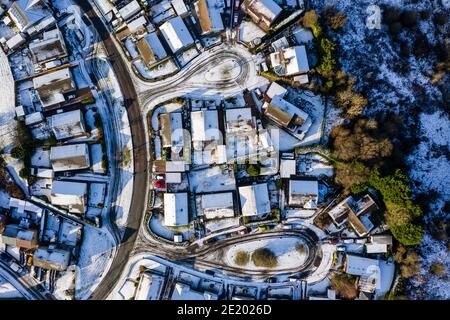 Vue aérienne par drone des petites rues résidentielles couvertes de neige en hiver Banque D'Images