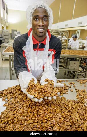 Alabama fort Deposit Priester's pecans Candy Maker, Black man travailleur de production employé enduit pecan, Banque D'Images