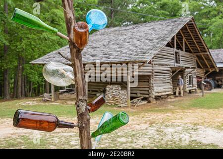 Alabama Troy Pioneer Museum of Alabama Bottle Tree, Kongo Tree autel West African tradition piégée spiritueux, grange en rondins, Banque D'Images